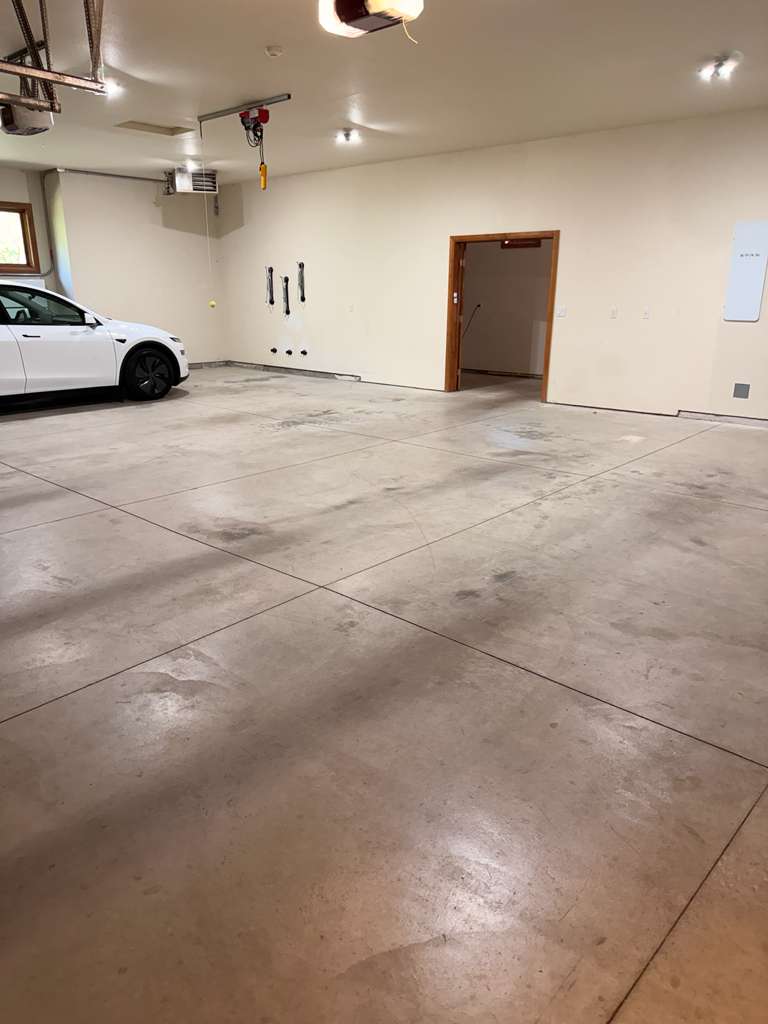 Boise garage before — bare concrete slab with tire marks and staining